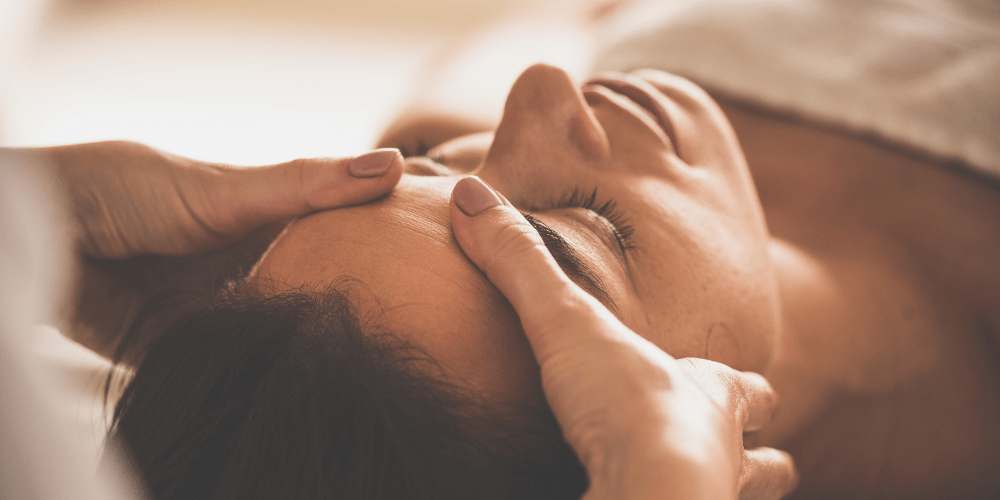 Woman getting facial massage during skin treatment